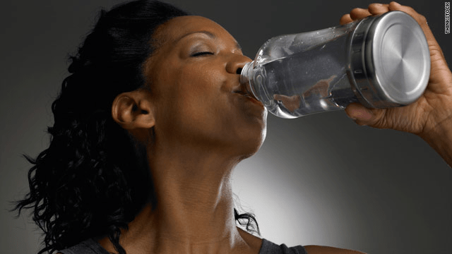 A woman with a bottle of water in one hand